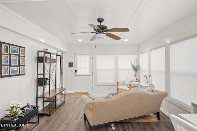 sunroom / solarium with wood ceiling and a ceiling fan