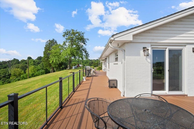 wooden terrace with a yard