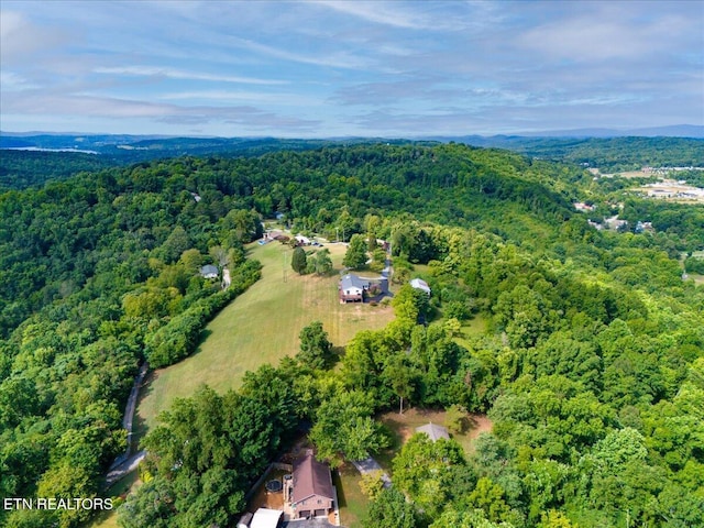 birds eye view of property featuring a view of trees