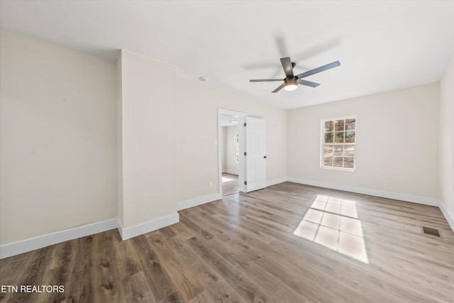 unfurnished bedroom with visible vents, ceiling fan, baseboards, and wood finished floors