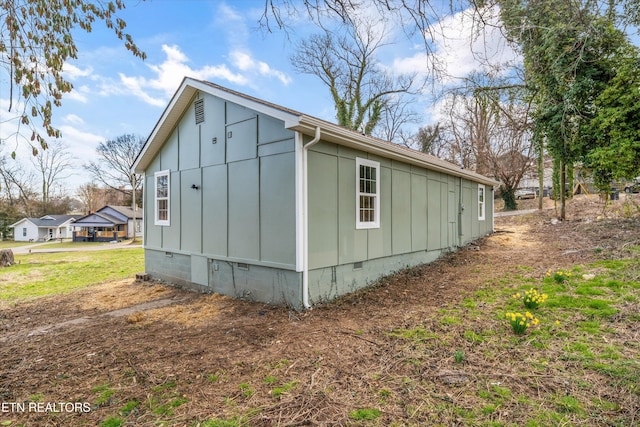 view of property exterior featuring crawl space and board and batten siding