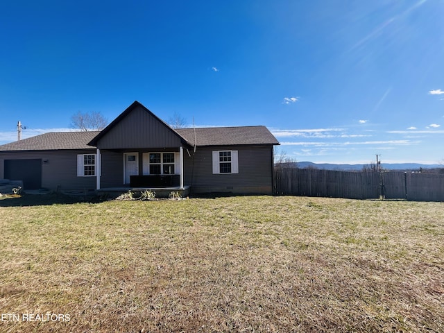 ranch-style home with roof with shingles, crawl space, an attached garage, fence, and a front yard