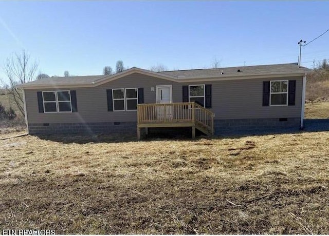 view of front of home with a deck, crawl space, and a front yard