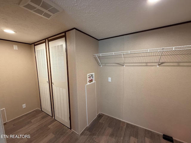 washroom with hookup for a washing machine, dark wood-style flooring, visible vents, and laundry area