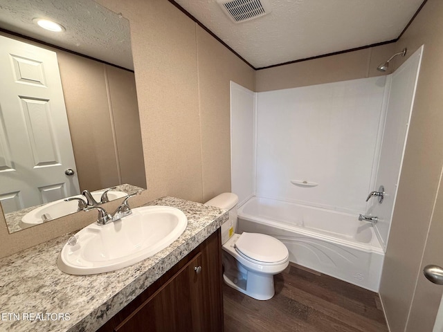 full bathroom with visible vents, toilet, shower / tub combination, wood finished floors, and a textured ceiling