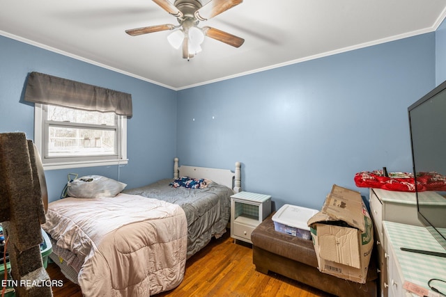 bedroom with ceiling fan, ornamental molding, and wood finished floors