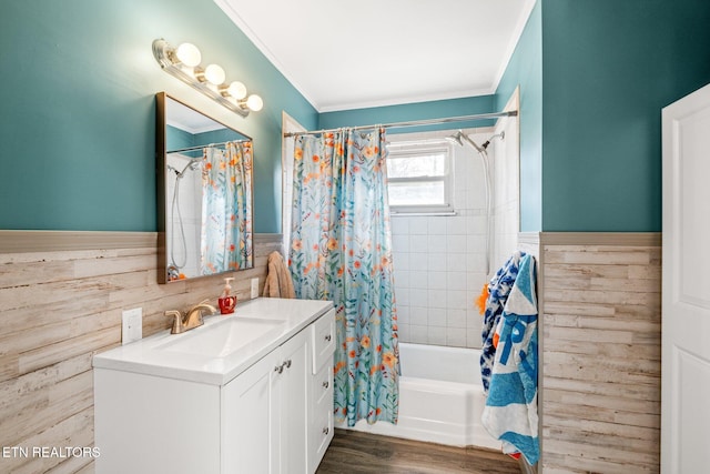 bathroom with ornamental molding, shower / bath combo, a wainscoted wall, and vanity