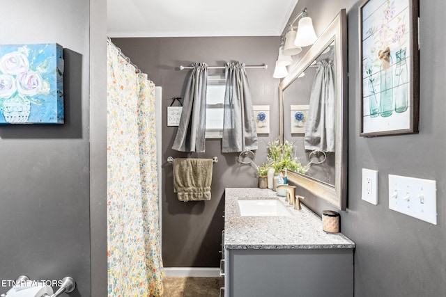 full bath with ornamental molding, vanity, and baseboards