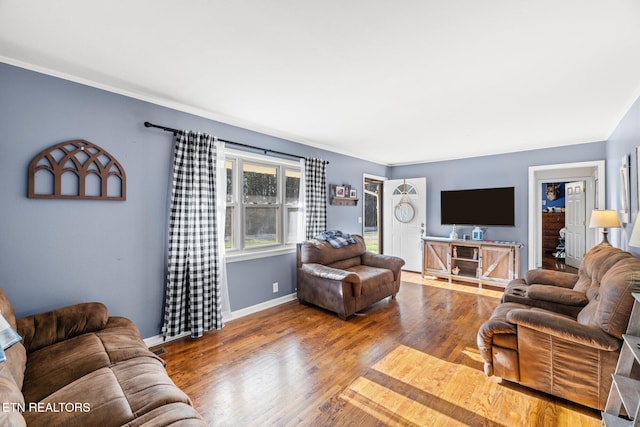 living area with wood finished floors and baseboards