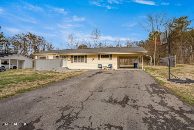 ranch-style home with crawl space, a front lawn, aphalt driveway, and an attached carport