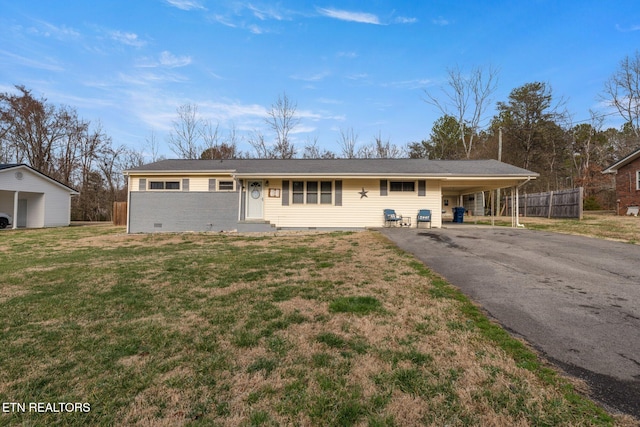 ranch-style home with crawl space, fence, an attached carport, driveway, and a front lawn