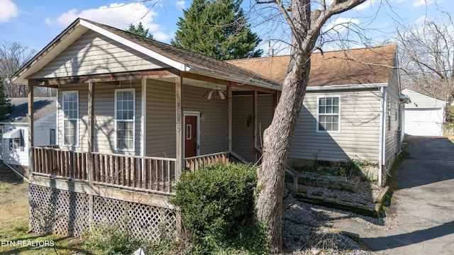 view of front of property featuring covered porch and roof with shingles