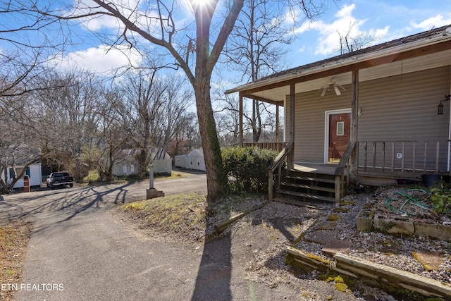 exterior space with a porch and a ceiling fan