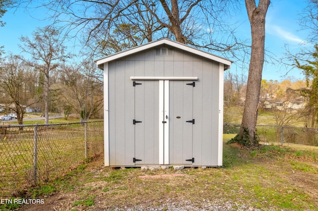 view of shed featuring fence