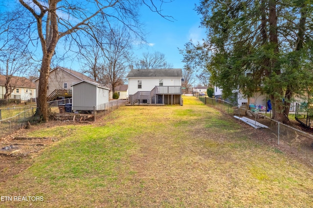 back of property with a fenced backyard, stairway, and a yard