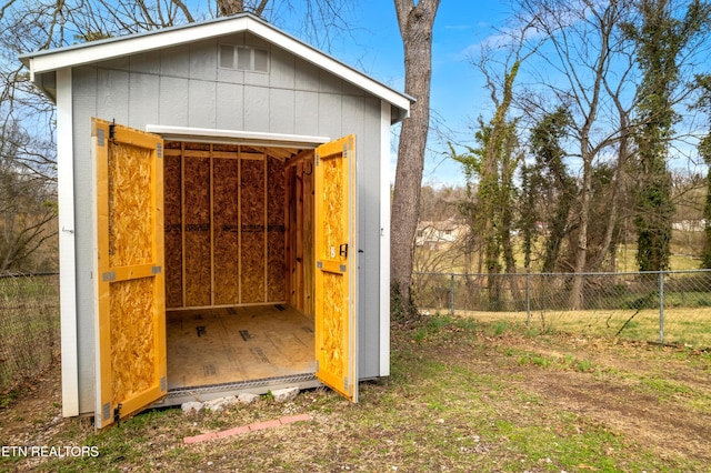 view of shed with fence