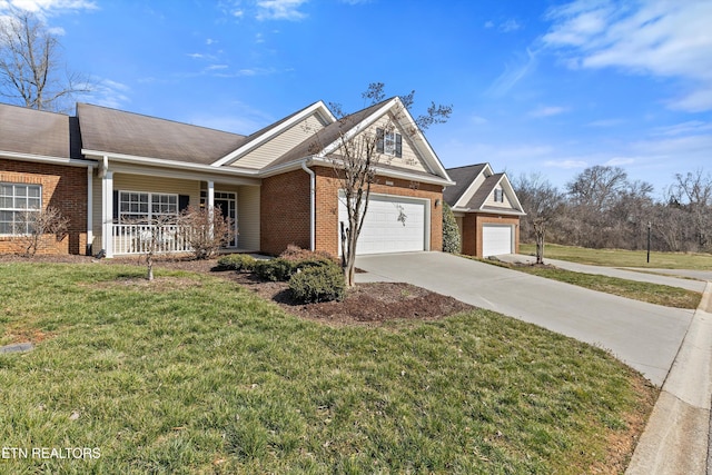 view of front facade with brick siding, concrete driveway, an attached garage, a porch, and a front yard