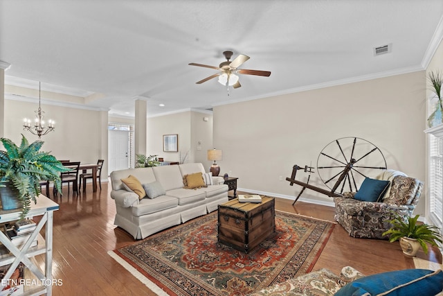 living area featuring ornamental molding, wood-type flooring, visible vents, and baseboards