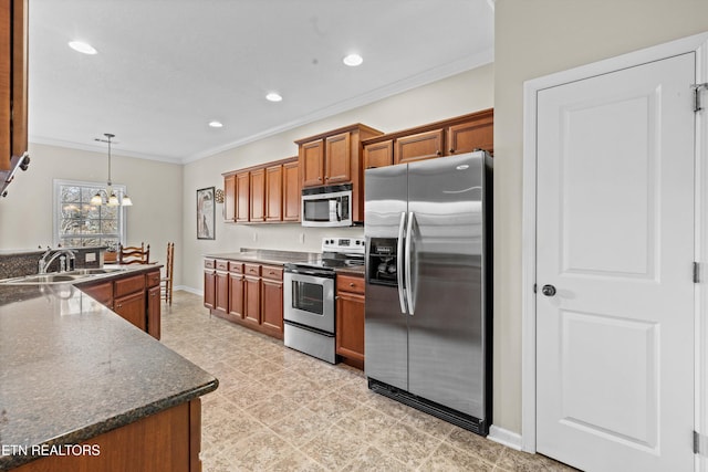 kitchen with a sink, ornamental molding, appliances with stainless steel finishes, brown cabinets, and an inviting chandelier