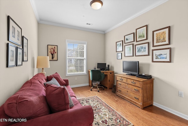 office area featuring light wood-type flooring, visible vents, crown molding, and baseboards