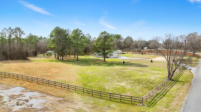 view of yard with a rural view and fence