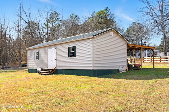 exterior space with a carport, entry steps, and fence