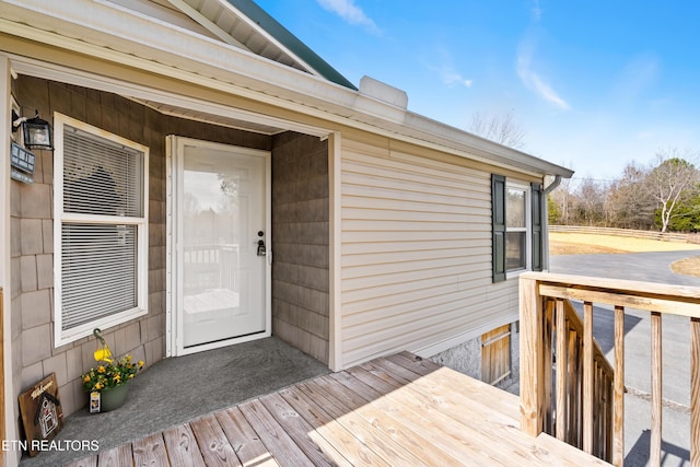 property entrance with a wooden deck