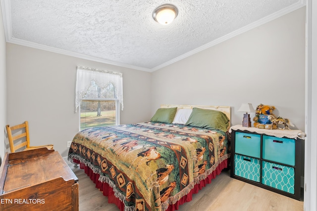 bedroom featuring light wood-type flooring, crown molding, and a textured ceiling