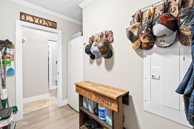 mudroom with a textured ceiling, ornamental molding, baseboards, and light wood-style floors