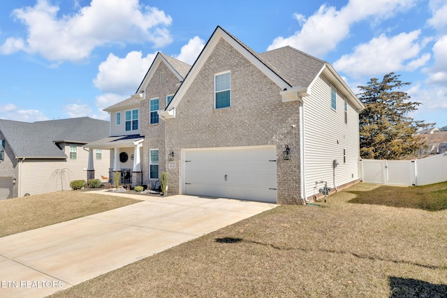 view of front of home with a gate, fence, a garage, driveway, and a front lawn