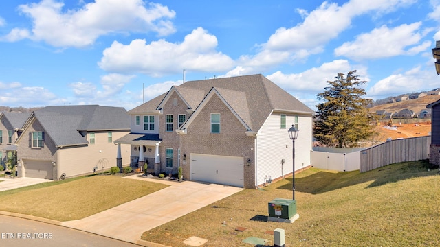 traditional home with a garage, a residential view, fence, and a front lawn