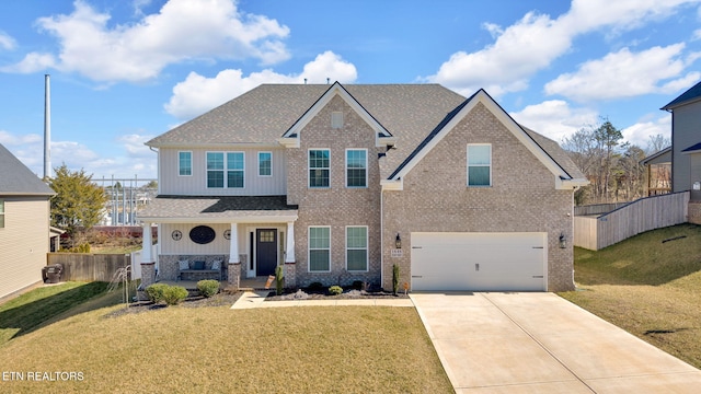 view of front of house with a porch, an attached garage, a front lawn, and fence