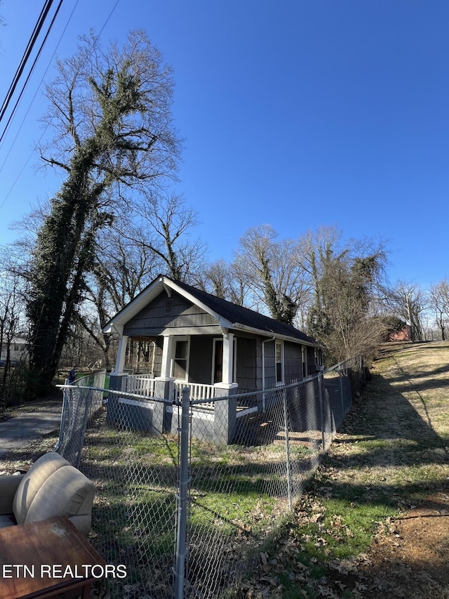 bungalow featuring covered porch and a fenced front yard