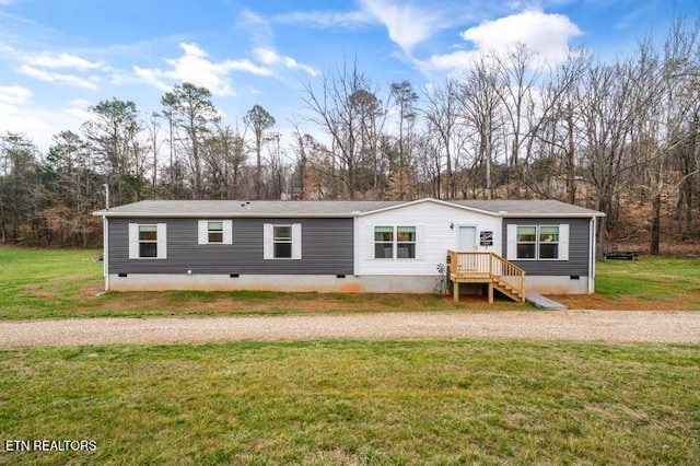 rear view of house with crawl space and a lawn