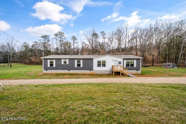 back of property with crawl space and a yard