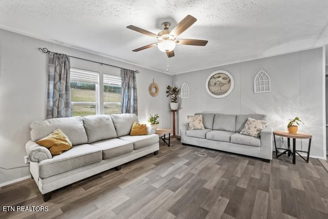 living area featuring ceiling fan, a textured ceiling, and wood finished floors