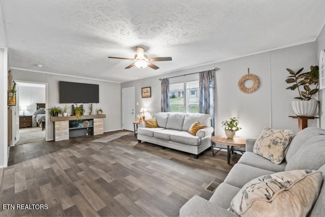 living room featuring ceiling fan, a textured ceiling, and wood finished floors