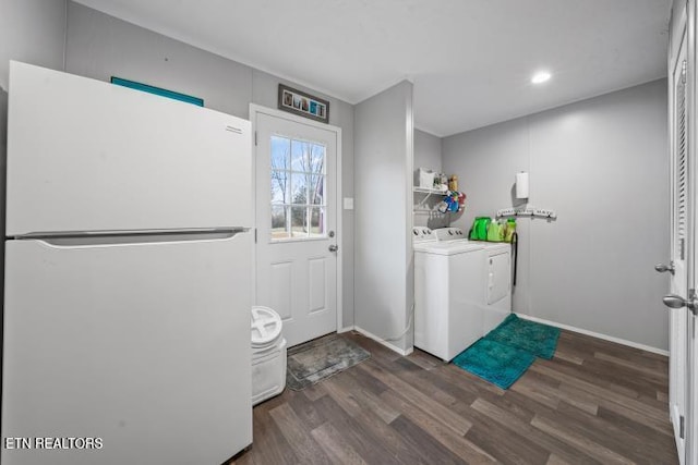 laundry area featuring laundry area, separate washer and dryer, dark wood finished floors, and baseboards