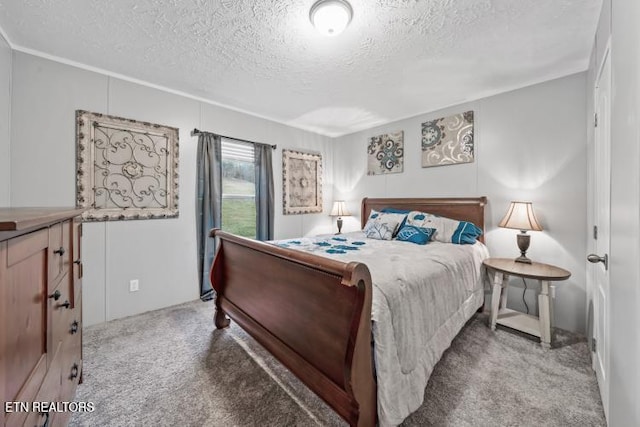 bedroom featuring carpet flooring and a textured ceiling