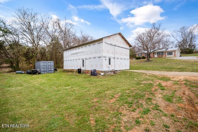 exterior space with a yard and an outbuilding