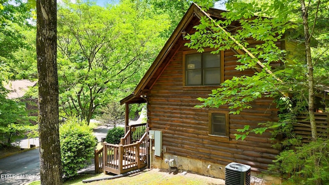 view of home's exterior with log siding and central air condition unit