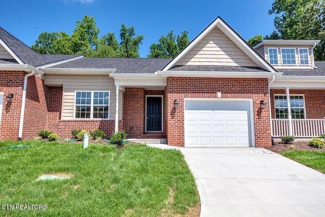 view of front facade with brick siding, a shingled roof, a front yard, a garage, and driveway