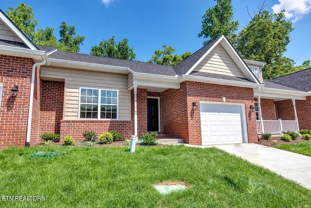 single story home featuring a garage, driveway, a front yard, and brick siding