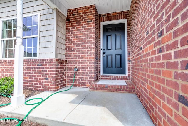 entrance to property with brick siding