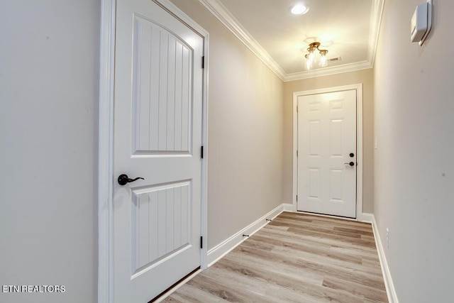 doorway to outside featuring baseboards, light wood-type flooring, and crown molding