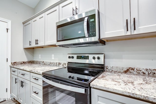 kitchen featuring white cabinetry and appliances with stainless steel finishes