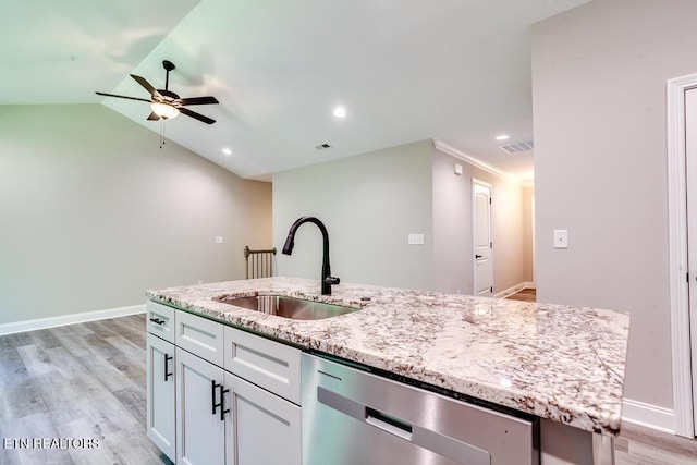 kitchen featuring a kitchen island with sink, a sink, white cabinets, light stone countertops, and dishwasher