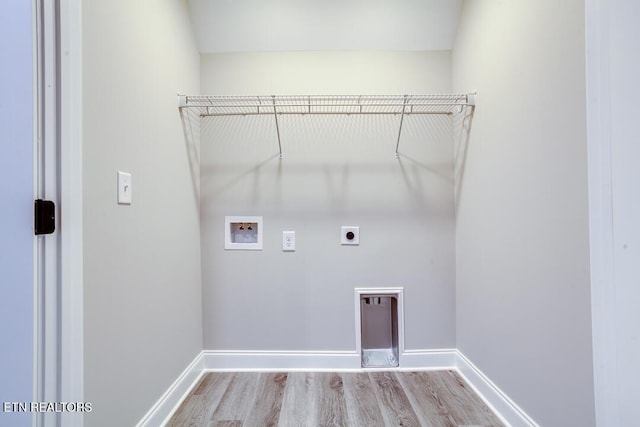 laundry room featuring washer hookup, light wood-style floors, hookup for an electric dryer, laundry area, and baseboards