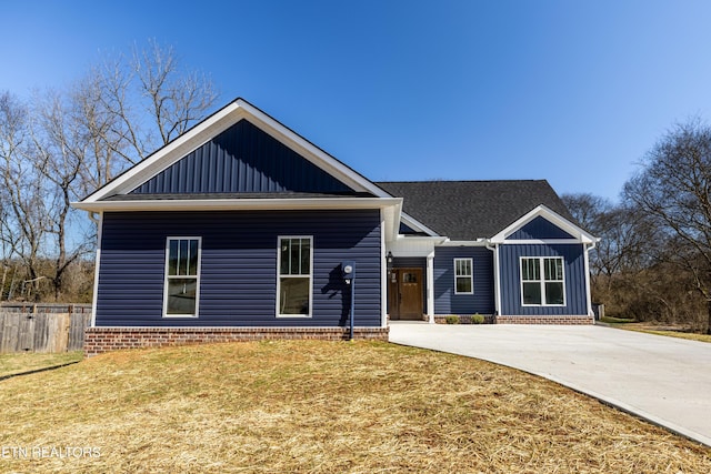 view of front of home featuring driveway, a front lawn, and board and batten siding