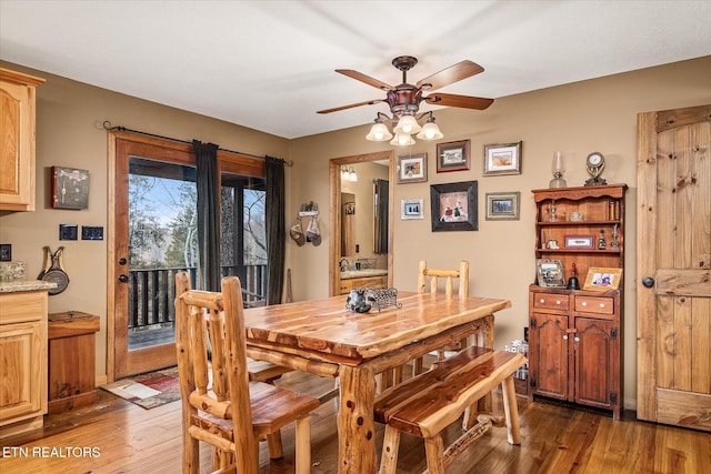 dining space featuring ceiling fan and dark wood-type flooring